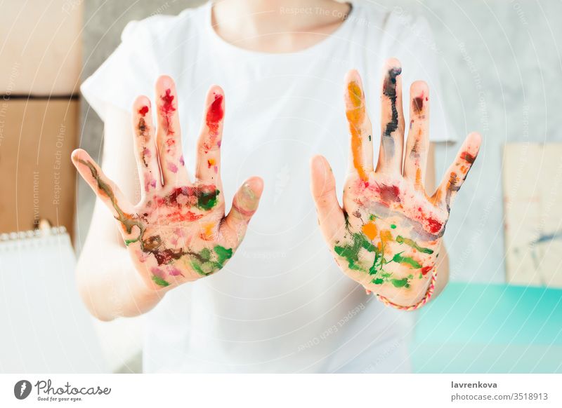Closeup of woman's hands painted with watercolors girl drawing person artist beautiful closeup colorful creative dye education female festive green hobby job