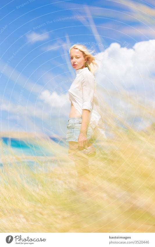 Free Happy Woman Enjoying Sun on Vacations. woman nature free happy summer wind freedom beach young girl beautiful beauty happiness outdoor white sunshine