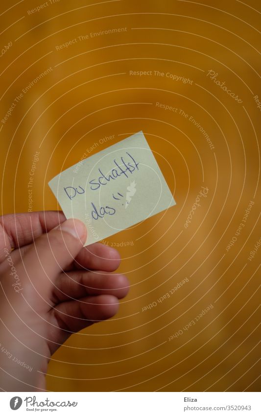 A Post-it or sticky note with a motivating handwritten message on it embolden sb. Motive post-it note on liability embassy by hand Paper Friendship