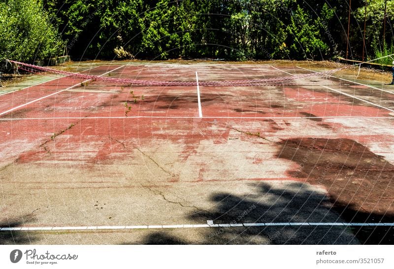 Grunge abandoned tennis court field sport game leisure nobody old view background green net wild plant grass tree vegetation empty bush play activity fence