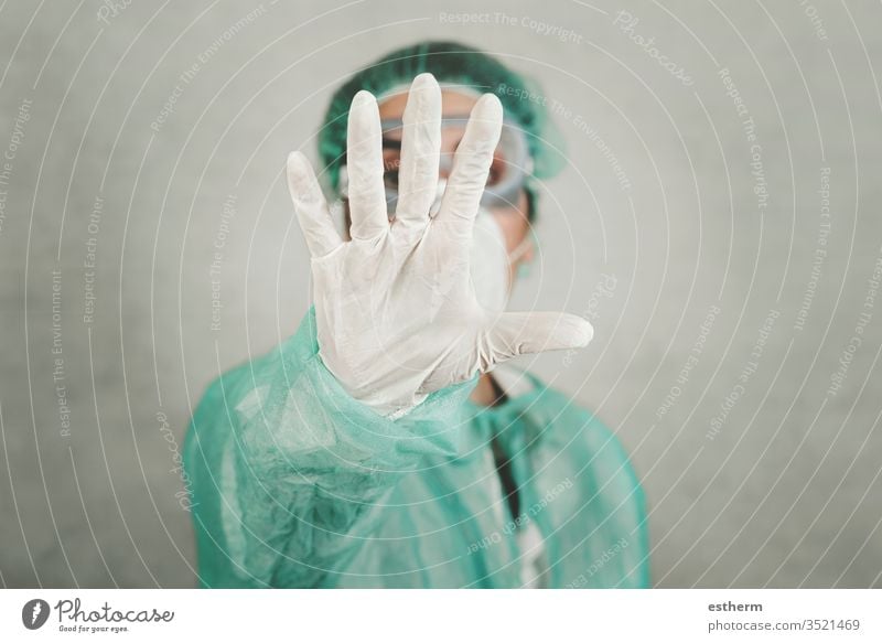 Stop coronavirus.Medical worker doctor showing a stop sign background blur epidemic pandemic quarantine covid-19 symptom medicine specimen health positive test