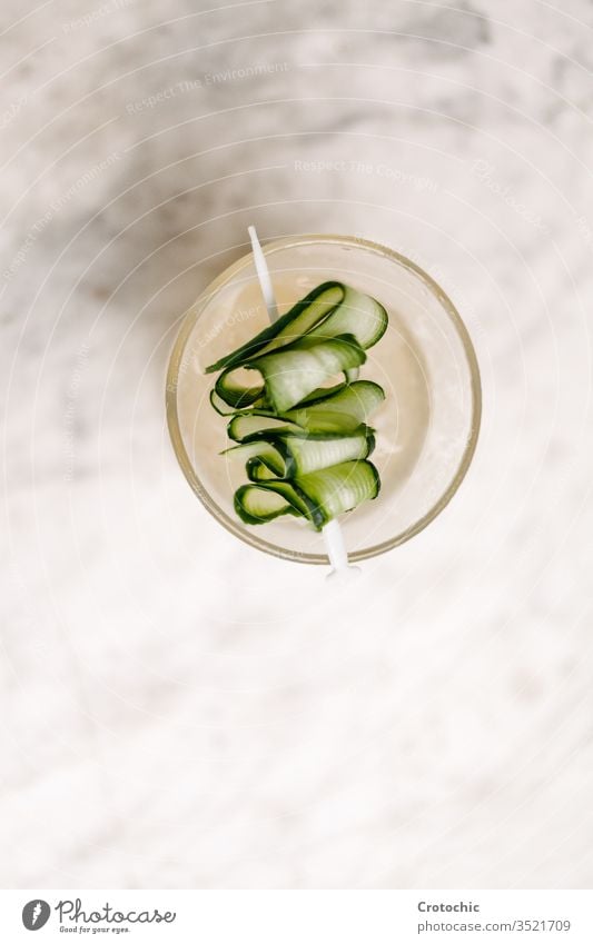 Plate with a cucumber skewer on a white background vertical aerial vegetable enjoyment food lifestyles rich twist cocktail delicate restaurant roll scented