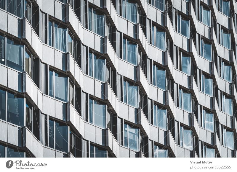 Irregular facade of an urban building creating a pattern windows architecture architectural architectonic metropolitan constructed edifice structure geometric