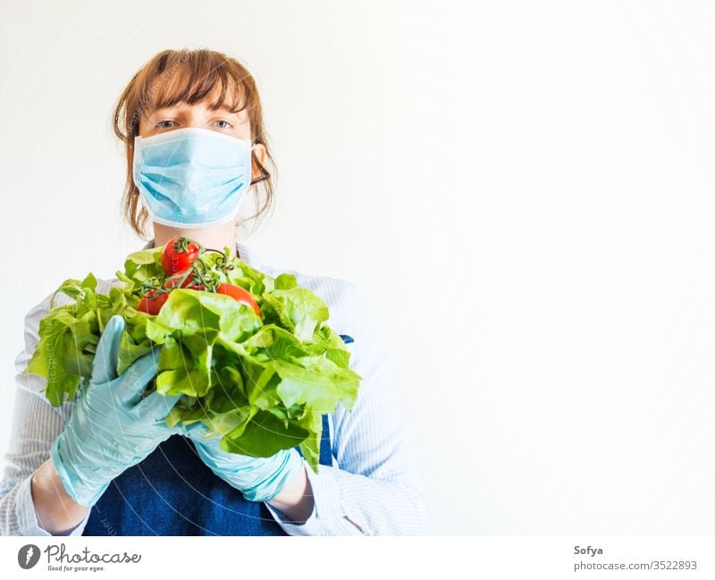 Woman in blue in face mask with fresh produce food delivery grocery store farm shop owner necessities hands safe staples girl foodstuff gloves holding online