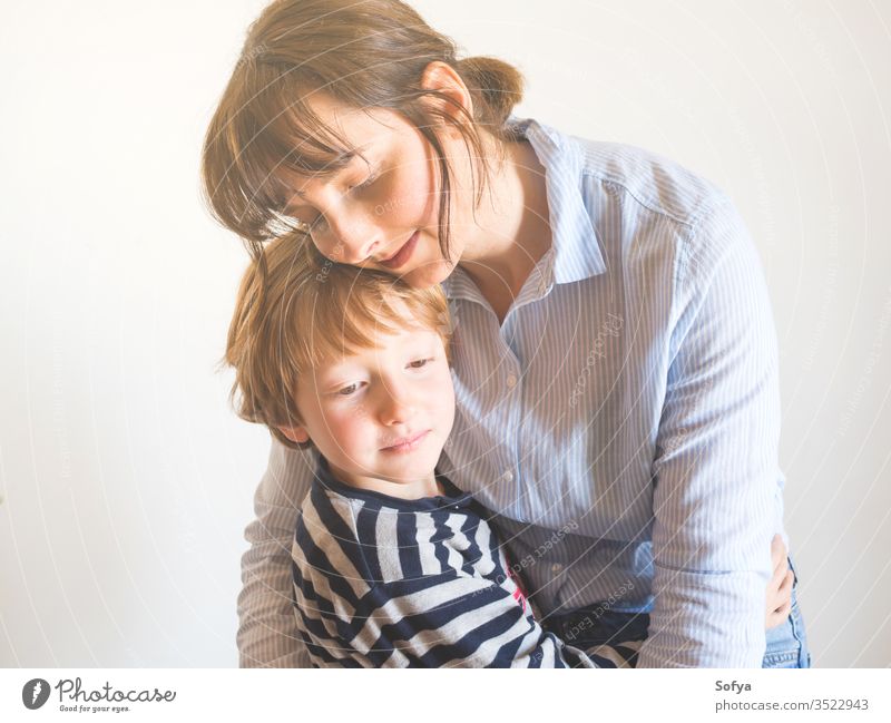 Young mother and child hugging. Mothers day mom parent mothers day woman lifestyle kid love son together family emotion feelings face eyes caucasian happy