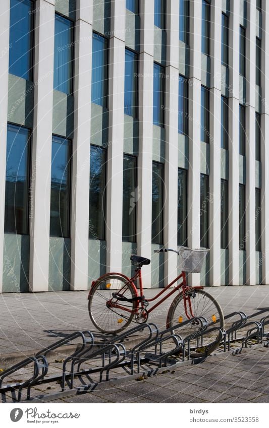 Parked bicycle in front of modern office building Bicycle Ladies bike Bicycle rack Office building Facade Modern Deserted Exterior shot Window Colour photo