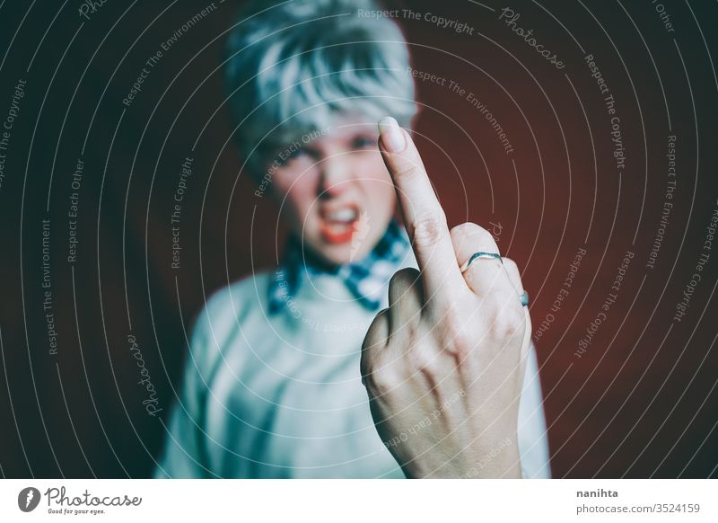 Portrait of a really angry androgynous woman rage rude sign expressive furious emotional mood portrait portraiture short hair red hair finger loud scream