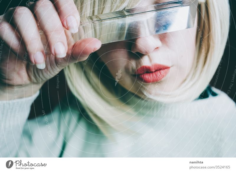 Close up of a young woman's face covering by a prism art close up glass crystal distortion reflection lips blond blonde mouth cold clean silence secret timidity