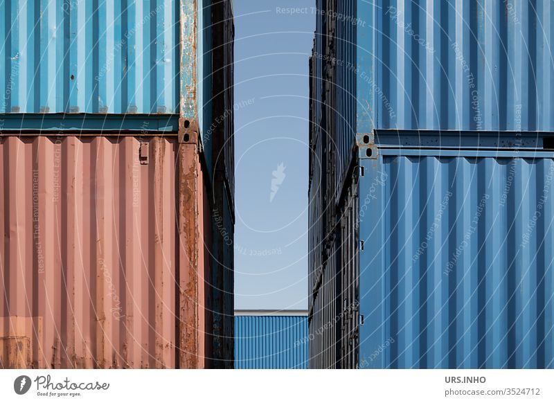 Detailed view of four storage containers stacked on top of each other with a gap in between Storage container Stack lines detailed view Blue Red Container