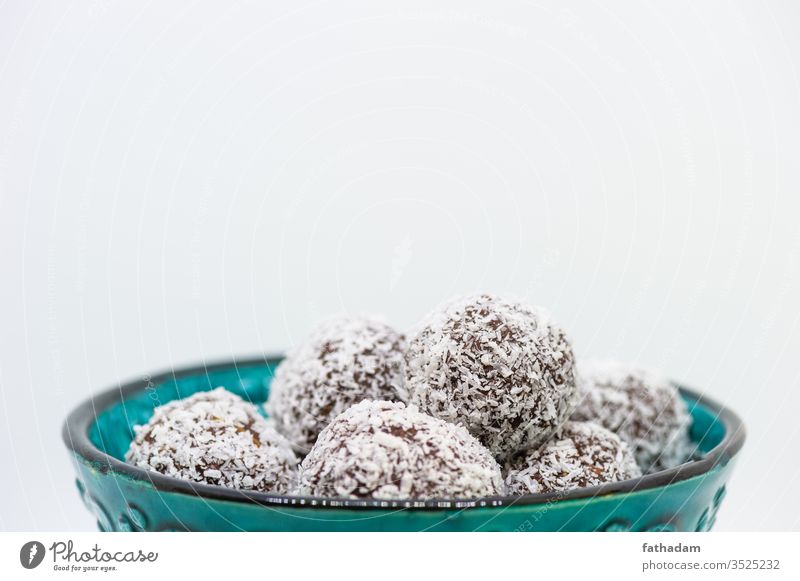 Coconut balls in a turquoise ball background bowl brown coco coco ball coconut coconut balls cookie delicious dessert food homemade isolated old bowl