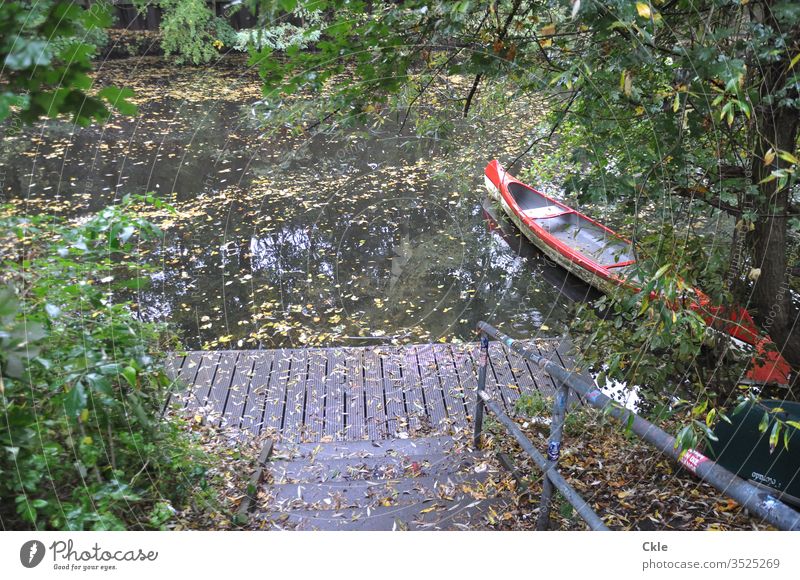 Lonely landing stage with canoe Canoe Water Lake Calm Watercraft Nature Sky Vacation & Travel Colour photo Reflection Trip Deserted River Exterior shot
