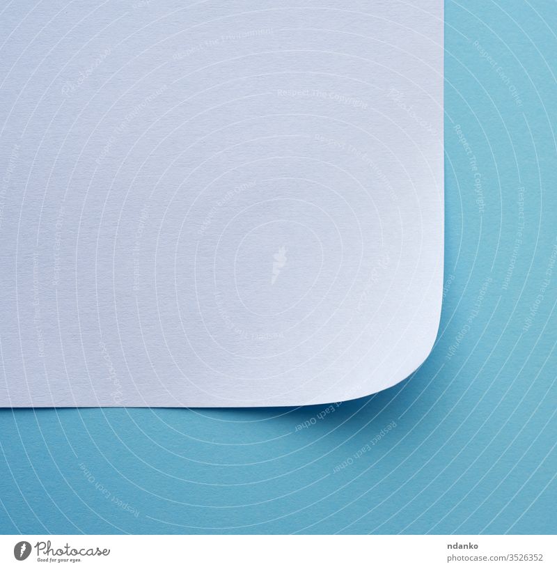 wrapped sheet of white paper on a blue background corner page blank curl edge document note texture frame space empty folded turn message design office clean