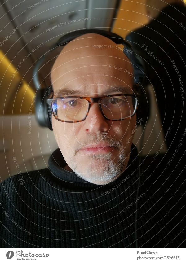 A man hearing music Only one man Adults Portrait photograph 1 Person glasses Person wearing glasses Airplane Eyeglasses