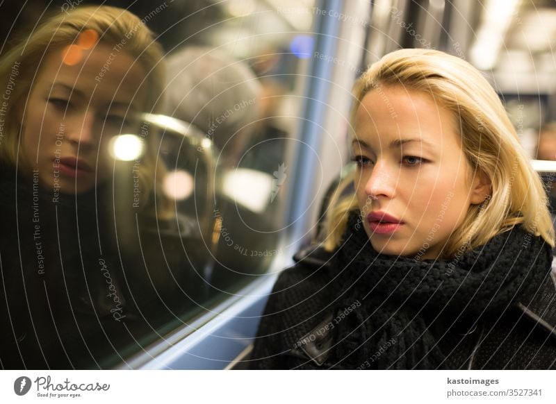 Woman looking out metro's window. transport portrait woman tube subway transpotation travel female urban view observe thoughtful trip sitting solitude interior
