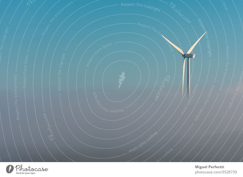Wind turbine wind turbine windmill mists clouds blue sky energy energy efficient ecology clean