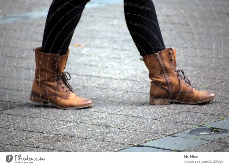 On the road in the city Going High heels Woman Legs Footwear Street Leather shoes Boots Brown Feminine Lifestyle laced shoelaces Zipper Paving stone Sidewalk