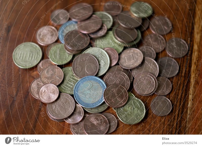 A pile of coins on a wooden table Money Coins Euro finance small change Save Money box cash box gratuity Business Paying Loose change Cent Colour photo savings