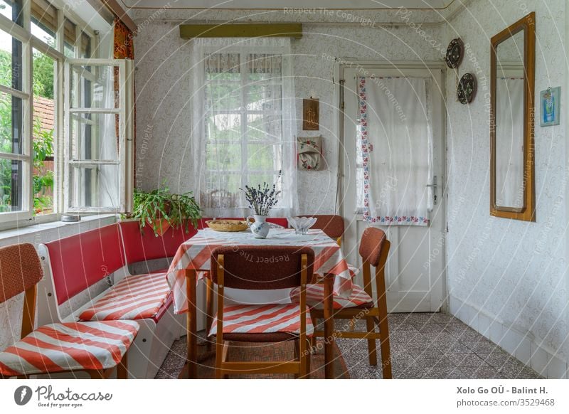 Tidy Dining room interior of an old traditional Hungarian folk house interiors socialism furniture rural countryside pattern wallpaper white red green nature