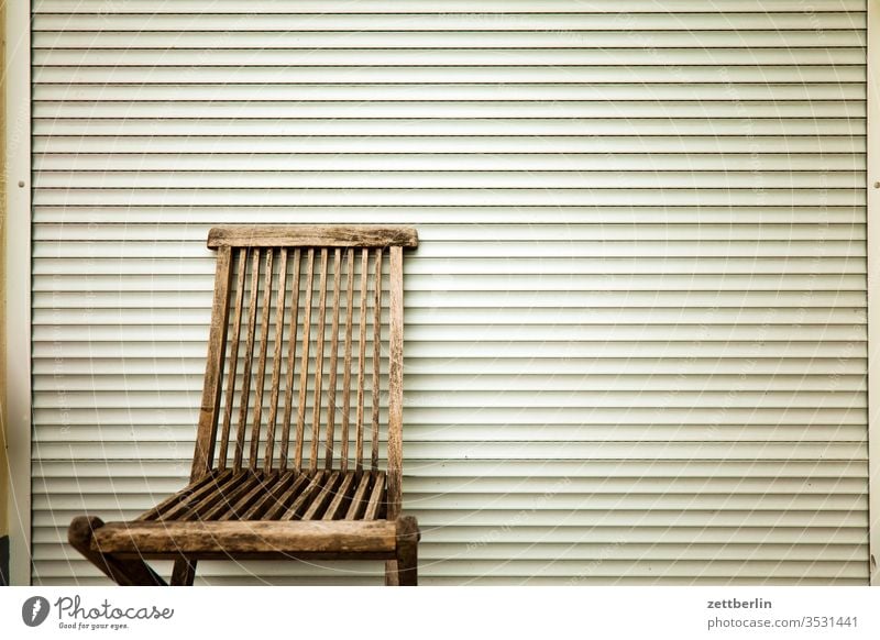 Garden chair in front of closed blind Venetian blinds Chair Folding chair Furniture Free Empty Relaxation holidays allotment Garden allotments Deserted