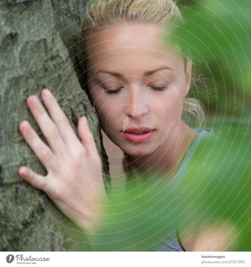 Young woman hugging a tree. hugger embracing embrace forest harmony trunk balance spiritual spirituality listen person wood green nature energy environment love