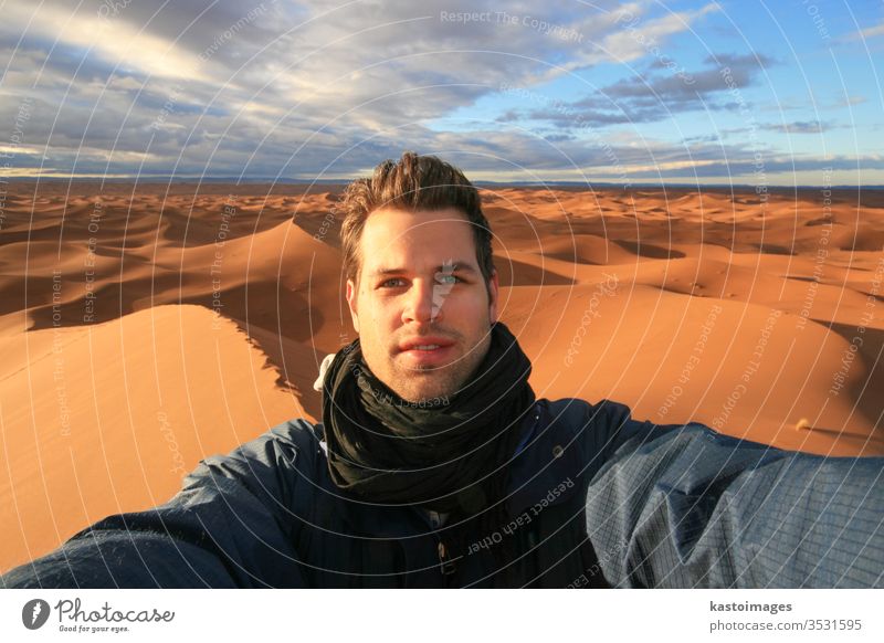 Male solo traveler taking selfie in Sahara desert, Morocco. africa portrait dry dune landscape man sand sun background beautiful dunes caucasian closeup