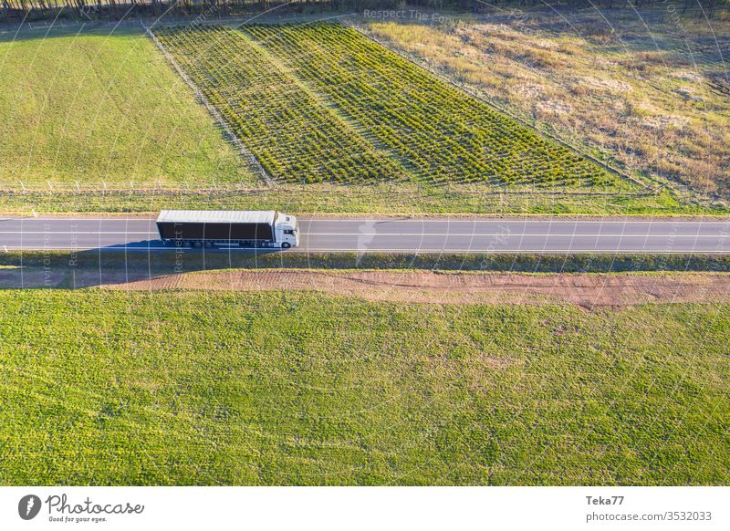 a cargo truck from above in an spring meadow landscape street street from above street with a car car driving car from above agricultural agricultural way rural