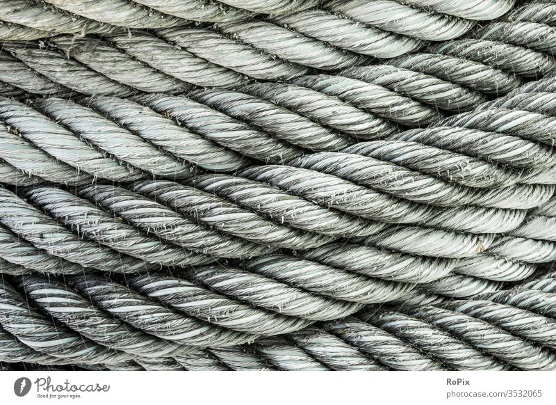 Detail of a roll of rope on a pier. Rope Dew ship Slings Harbour technique Strength holds seafaring Business Company Hull Commerce wickerwork business Mechanics