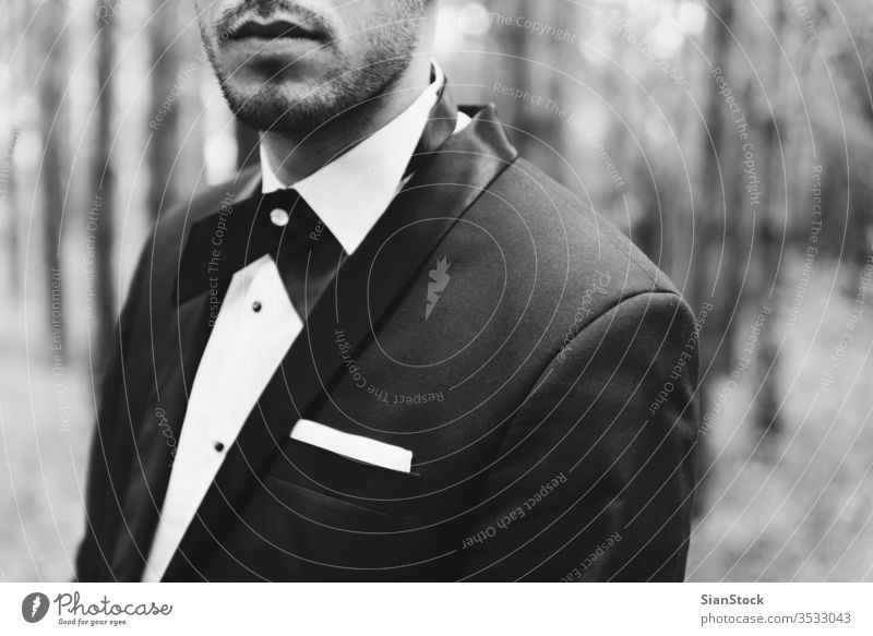 Groom at wedding tuxedo in the forest groom black white man elegant happy jacket b&w background person tie portrait handsome dress young people fashion luxury