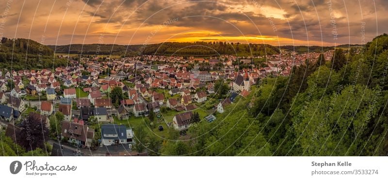 Germany, Albstadt at the Schwaebische Alb skyline of medieval city illuminated by the dawn, aerial view above roofs and houses at sunset albstadt town drone