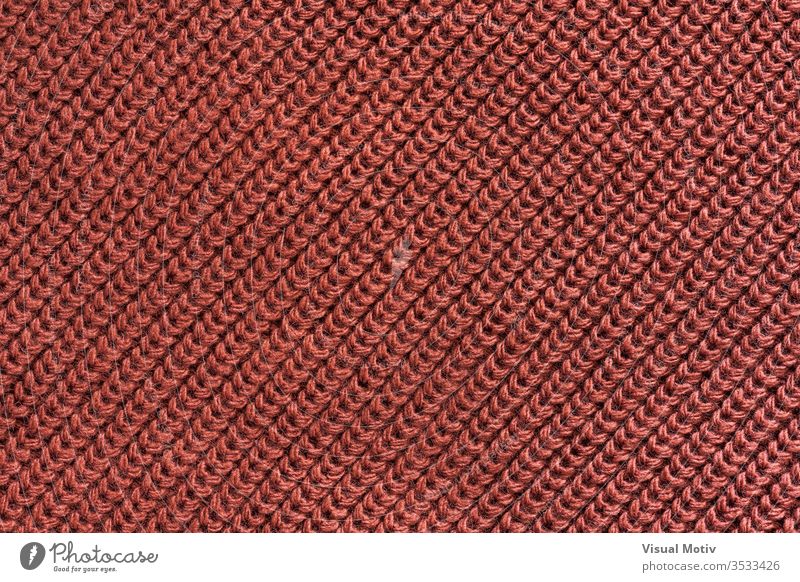 Texture of a red wool knitted fabric textile textured fashion background surface design abstract closeup nobody detail knitwear clothing material relief woolen