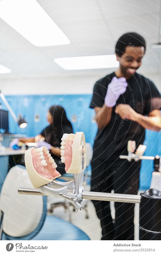 Denture on occludator in orthodontic laboratory denture modern clinic staff metal professional equipment false teeth ethnic job medicine hospital holder