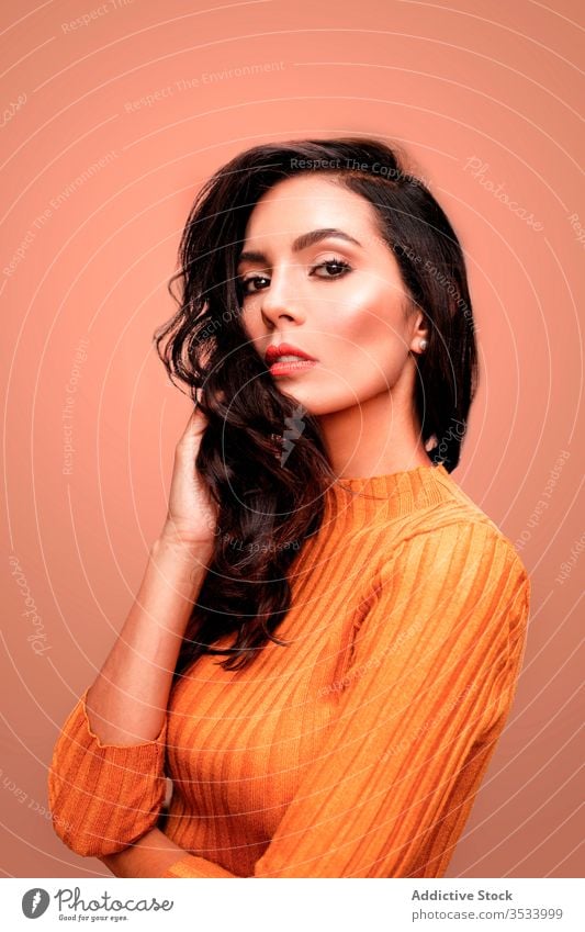 Sensual female model in orange outfit woman style fashion confident sensual color bright vivid young trendy casual colorful lady beautiful beauty makeup