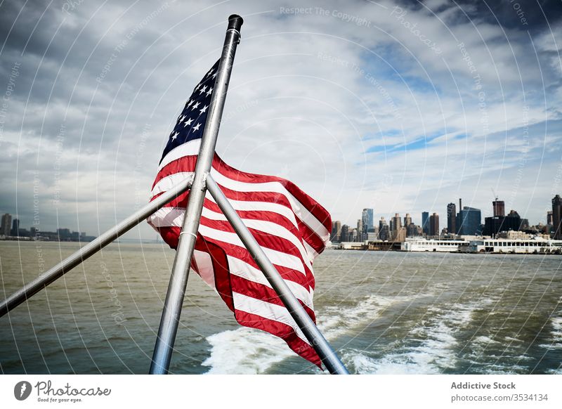 American flag on floating boat national usa vessel water city coast sky cloudy american united states new york nyc patriot wave building wind cityscape travel
