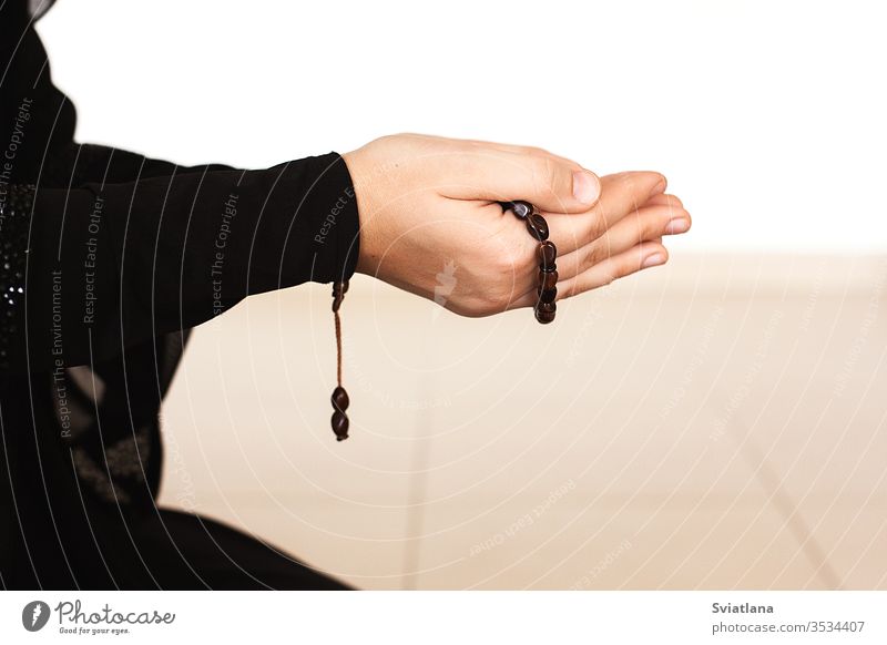 Prayer hands of a woman holding a rosary beads muslim symbol pray religion faith holy islam prayer allah god meditation Ramadan traditional white arabic
