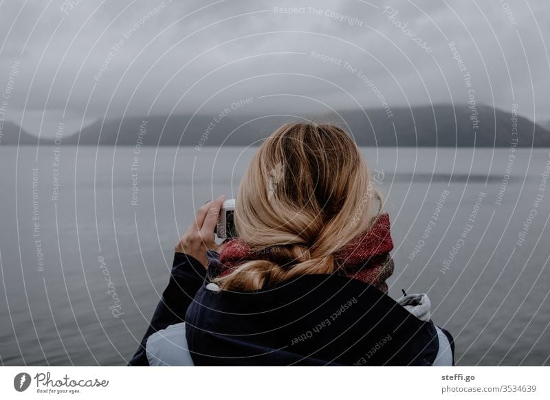 Woman photographs seascape in Scotland with a camera Great Britain Europe Bad weather Fog Lake Loch Ness Nessi Nessie Nature Landscape Clouds Colour photo