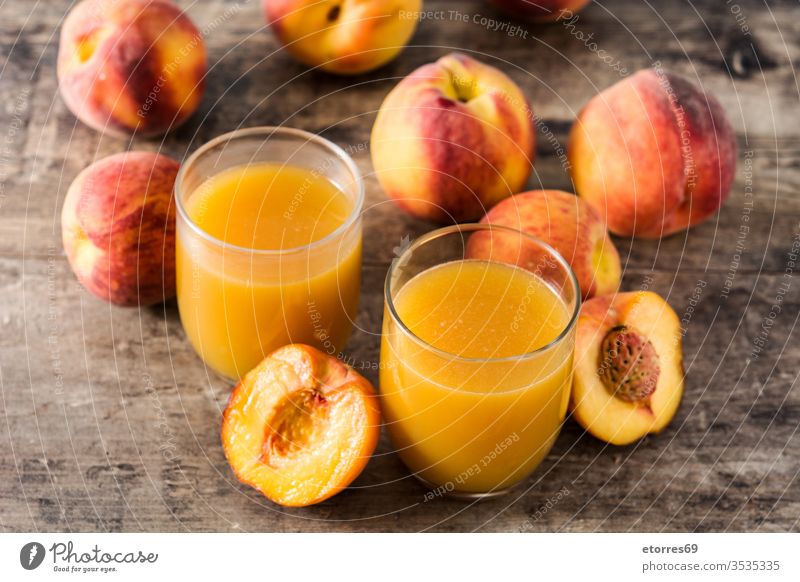 Natural peach juice in glass on wooden table beverage breakfast cup diet drink food fresh freshness fruit healthy juicy liquid nutrition organic refreshment