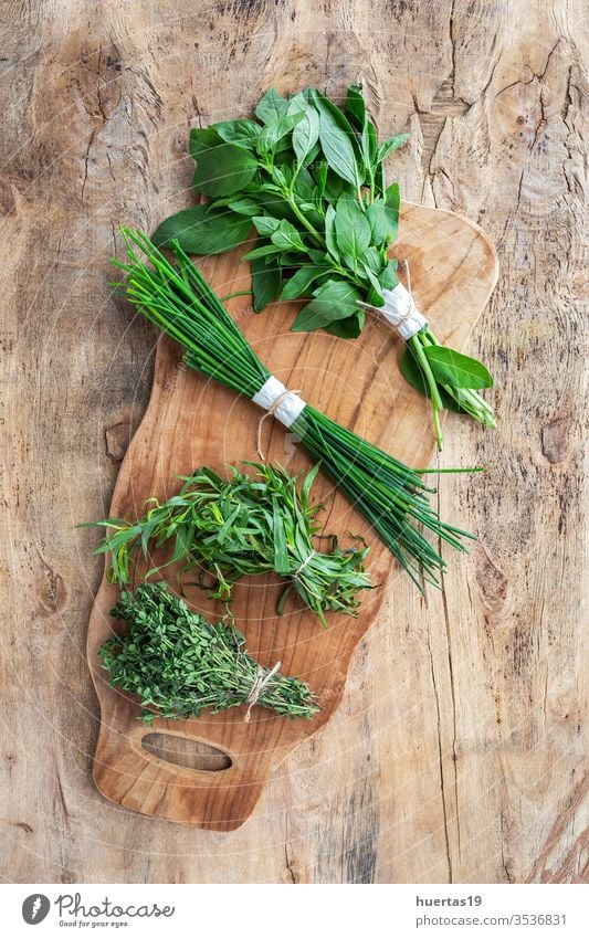 fresh aromatic herbs from above on old wooden ground Aromatic Herbs Food Organic green Component background Mint Oregano Parsley Chives Rosemary Basil Tarragon