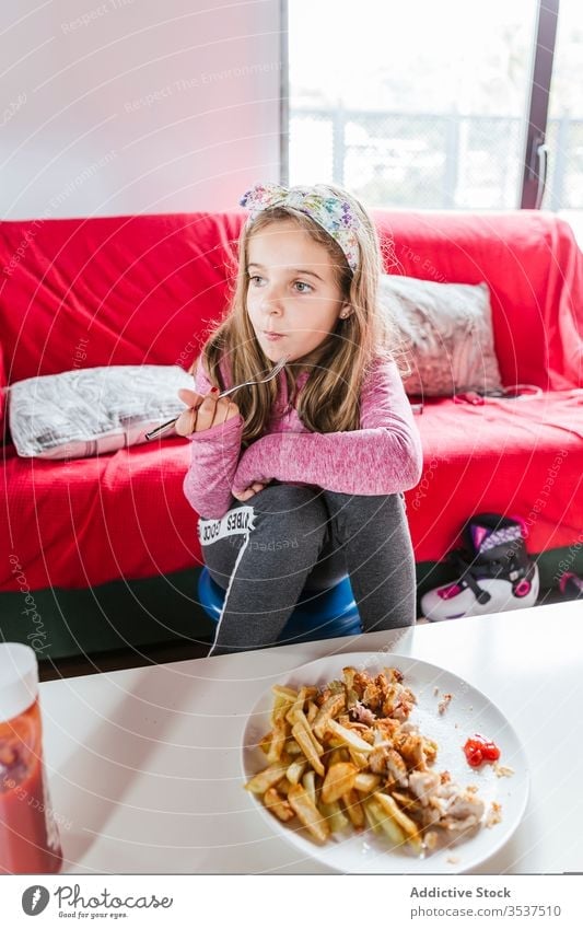Girl eating lunch meal at home girl dinner living room food sofa sit rest casual tasty dish kid child nutrition yummy cozy lifestyle relax delicious comfort