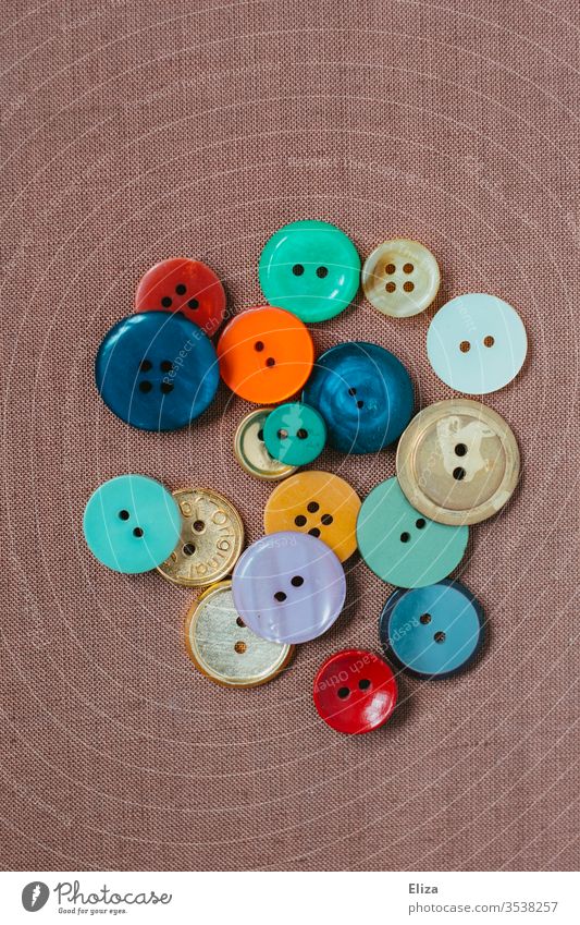 Various colorful buttons on pink background Buttons variegated diverse Sewing Collection Handcrafts Tailor Craft (trade) colourful Round amass Tailor's shop
