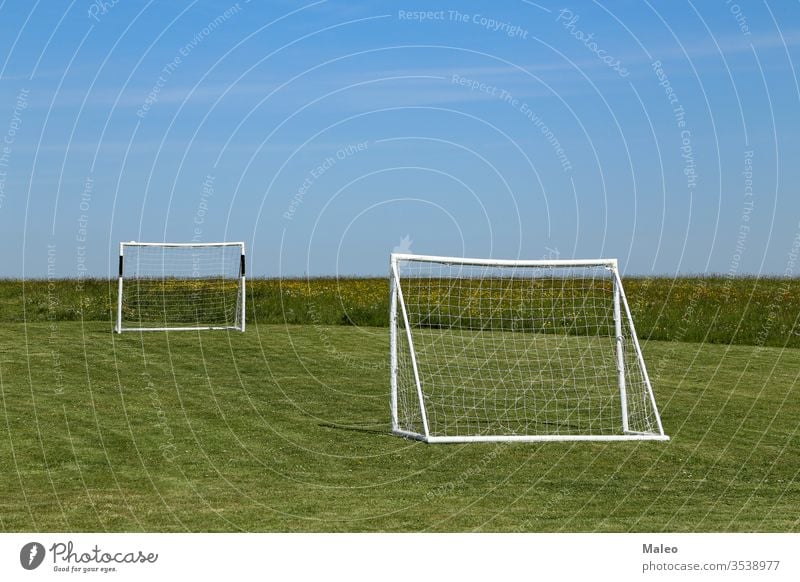 Football goal stand on a green lawn soccer field football gate net grass playground stadium competition game leisure sport turf night backgrounds europe fun