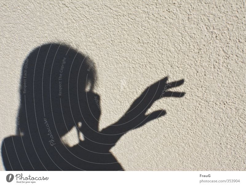 shadow plays Feminine Woman Adults Head Hand Fingers 1 Human being 45 - 60 years Beautiful weather Facade Black Take a photo Shadow Indicate Shadow play