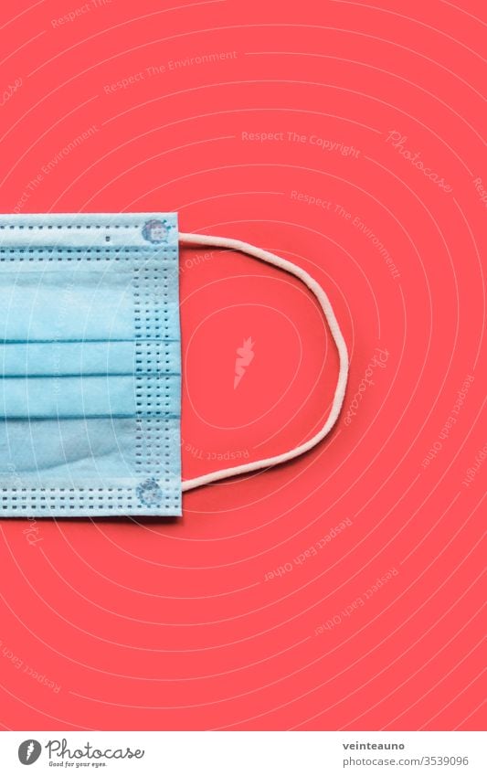 COVID-19 disposable surgical face mask on red background. Protection against coronavirus. Healthcare and medical concept covid19 surgical mask pattern blue