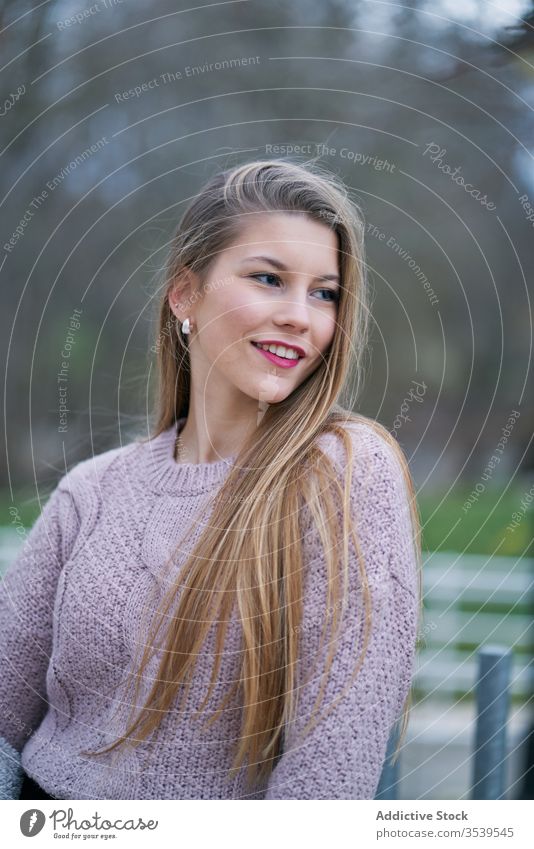 Positive young female student with flowing hair in park woman smile individuality kind positive mood personality portrait happy walk care dreamy human face