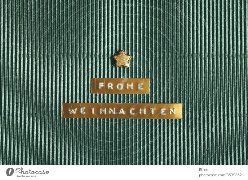 Golden label on the Merry Christmas stands with a golden star on turquoise corrugated board merry christmas authored christmas greeting Christmas card Stars