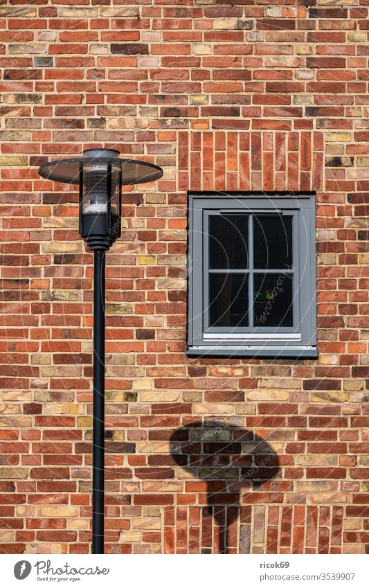 Detail of a building with lantern in Rostock detail Architecture Window Lantern Shadow Manmade structures built House (Residential Structure) Facade Brick