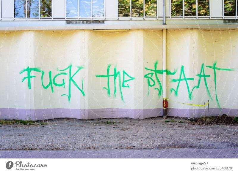 Fuck the State | Graffito on a beige facade Graffiti green lettering Characters Wall (barrier) Wall (building) Facade Colour photo Exterior shot Deserted built