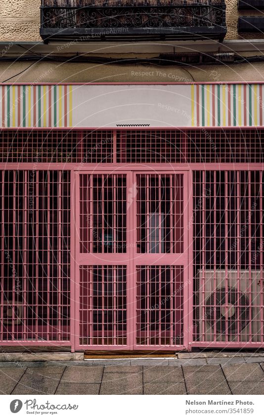 Pink texture of a door with lines and shapes. pink street color design background garage stripe