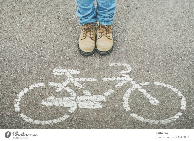 chil next to Bike Symbol on Street street urban bike cycle bicycle cyclist rider biker shoe people hobby warning healthy cycling walk pavement icon shoes