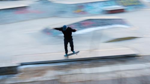 A skater in motion at a stunt action active activity Art awesome balance Berlin blur effect blurry board city citylife cityscape cool culture equipment extreme