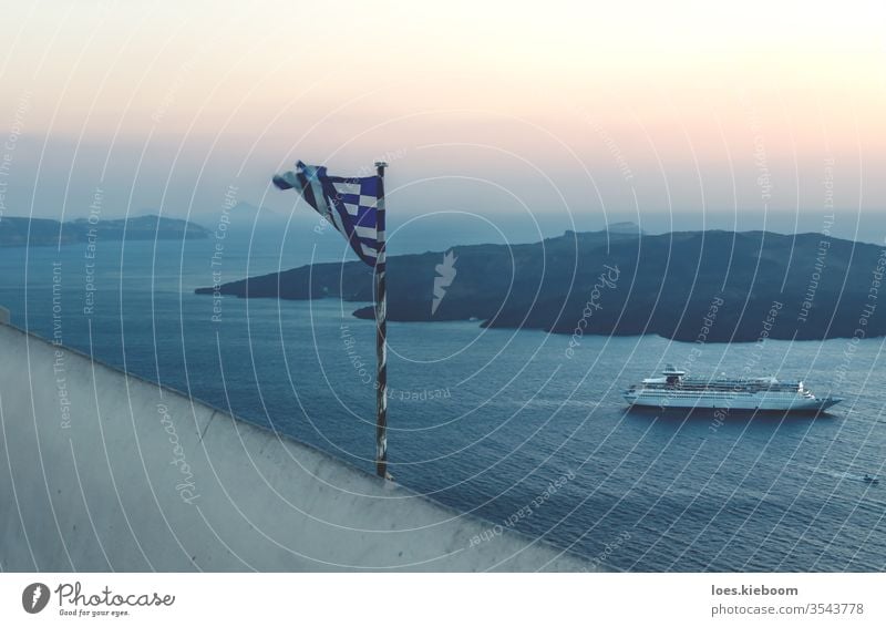 Torn Greek flag along the sunset coast with cruise ship in Fira, Santorini, Greece santorini torn greece summer sky travel ocean sea tourism nature landscape